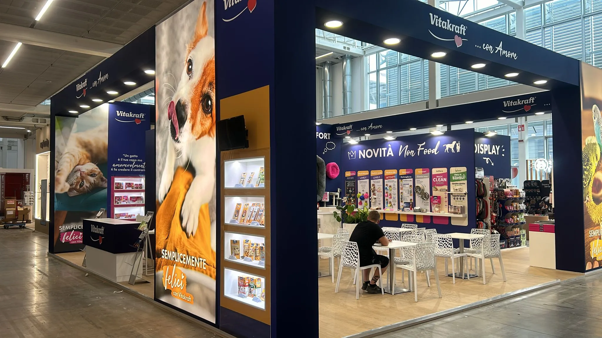 Stand Vitakraft a Zoomark, vista d'angolo con grafiche cane e gatto e scaffalature prodotto